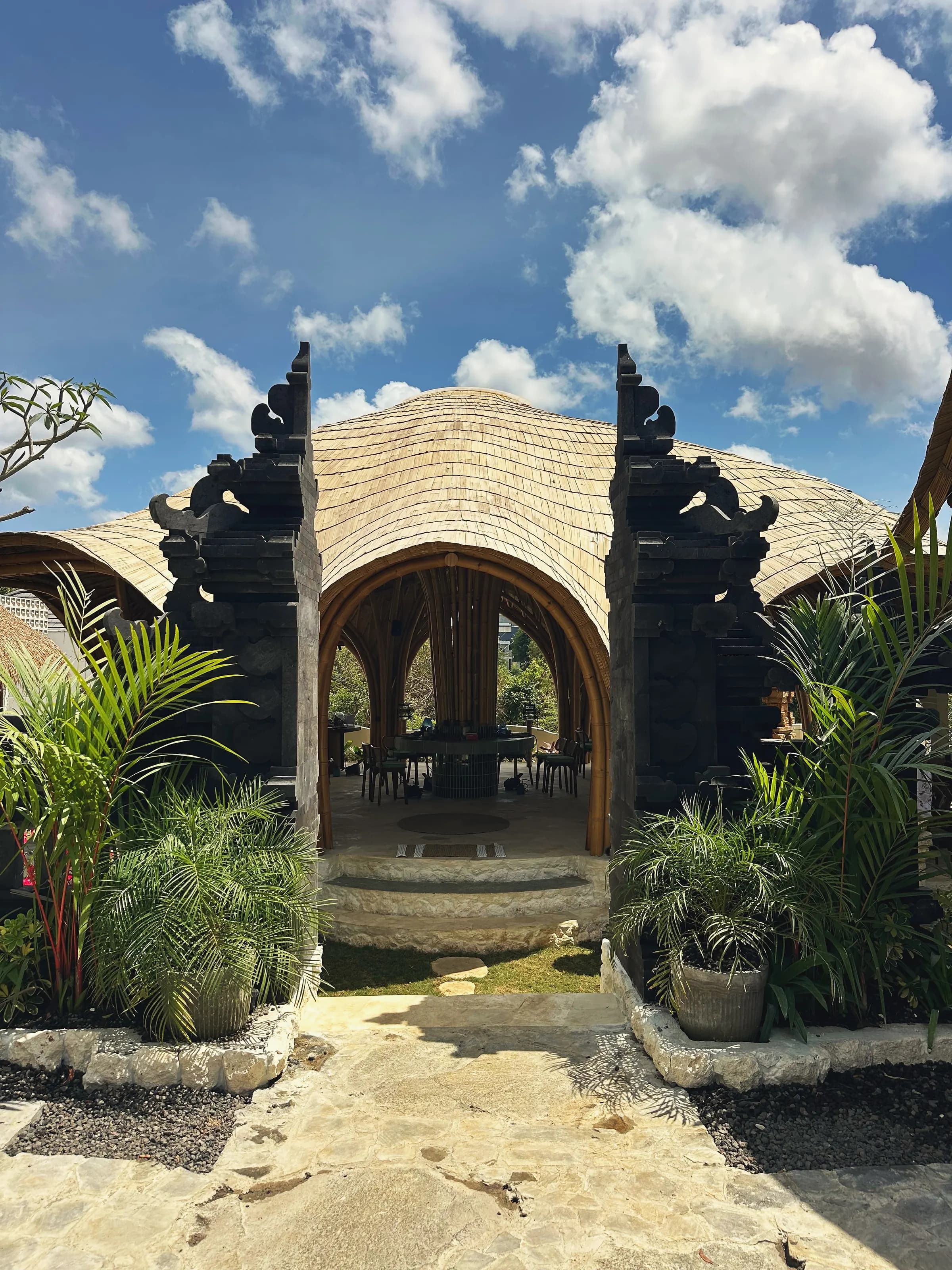 The carved candi gate of Bali Jewelry House opening onto the bamboo main house