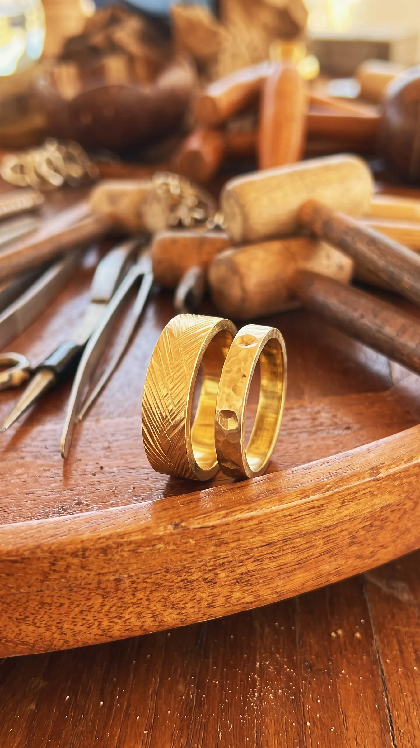 Two gold-plated brass rings from the Brass Jewelry Workshop, one engraved and one hammered